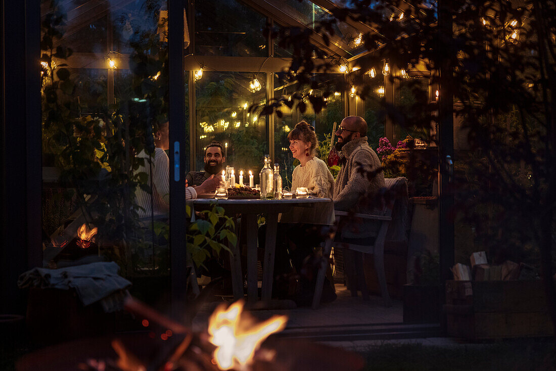 Friends having meal in greenhouse