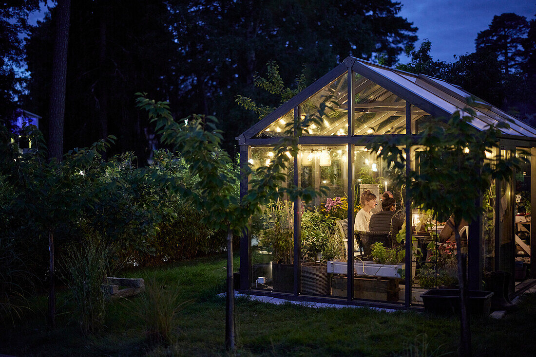 People having meal in greenhouse