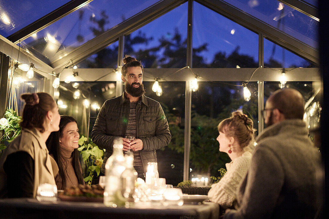 Friends having evening meal together