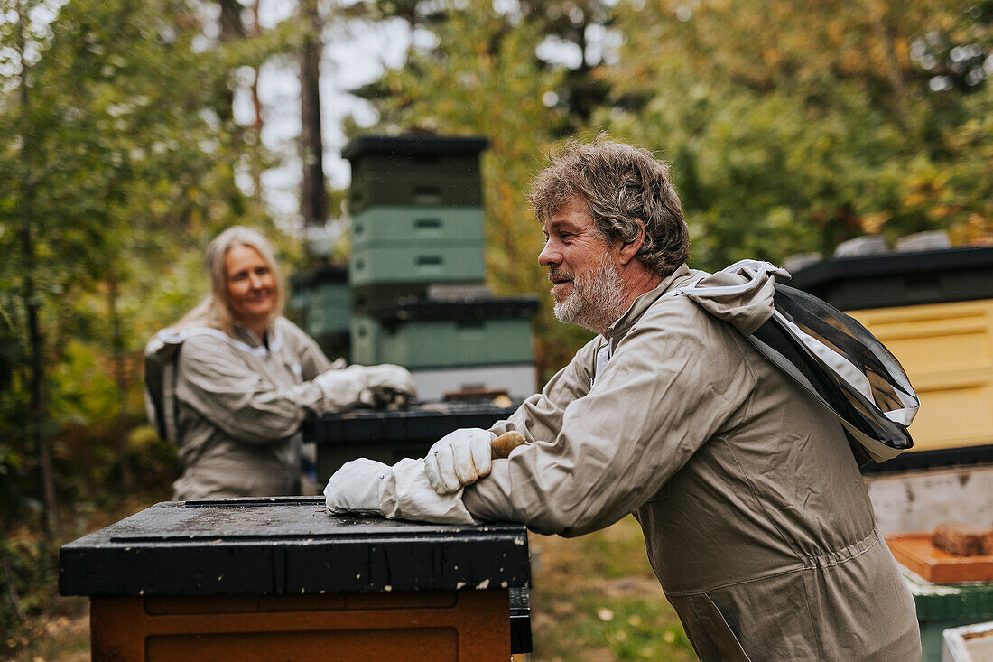 Beekeeper standing near beehive