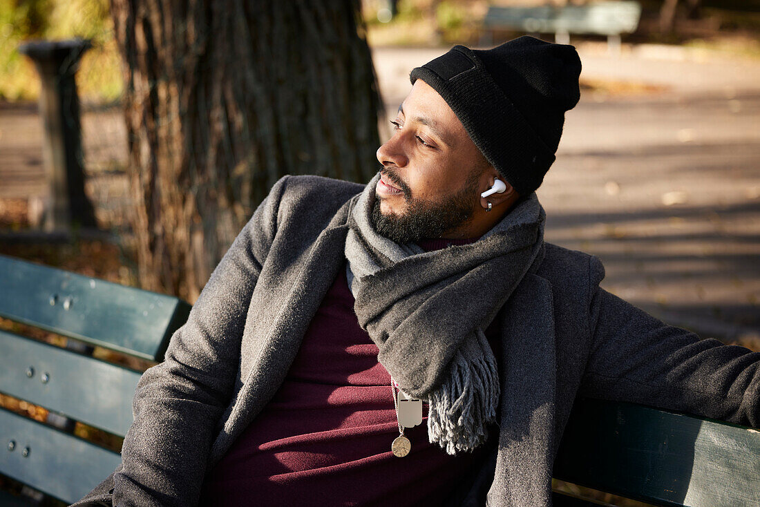 Smiling man sitting on bench