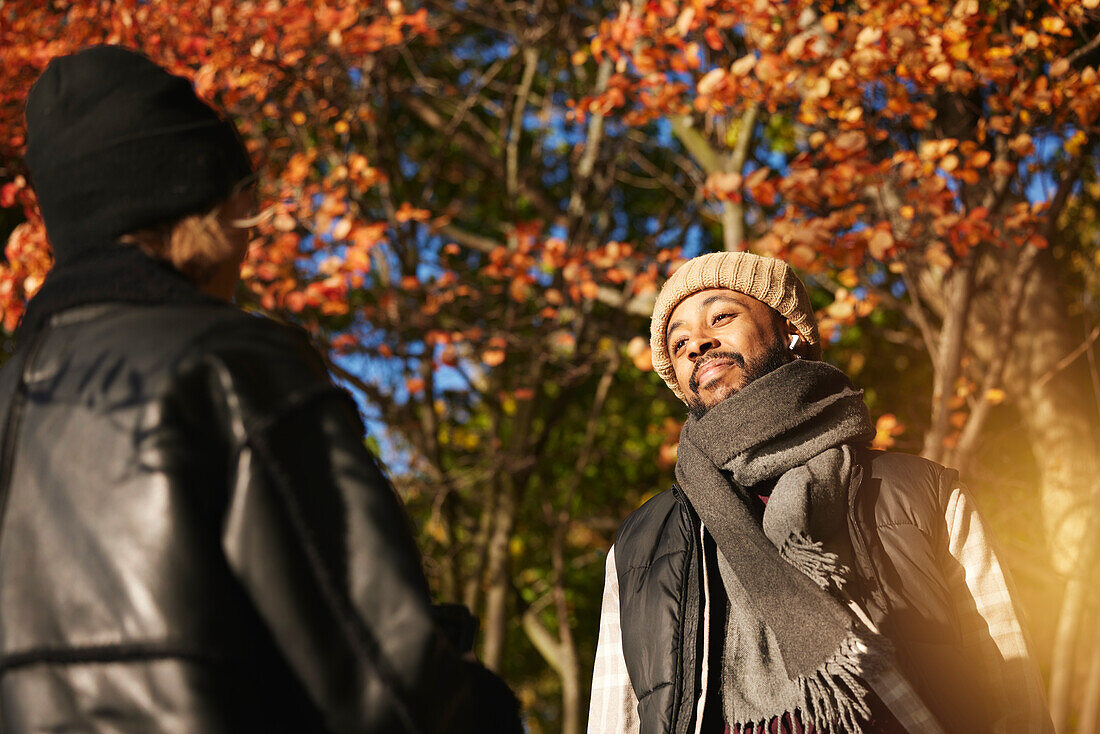 Smiling man talking to friend