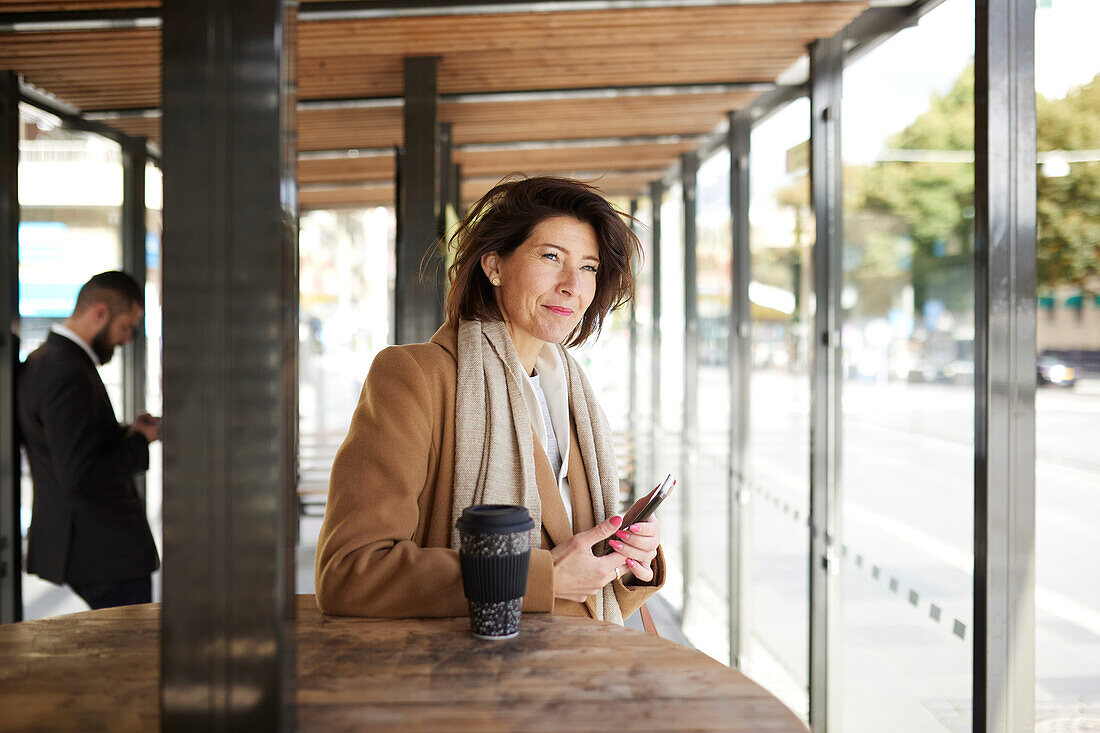 Smiling businesswoman looking away