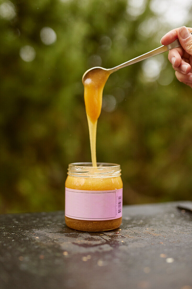 Honey being poured into jar