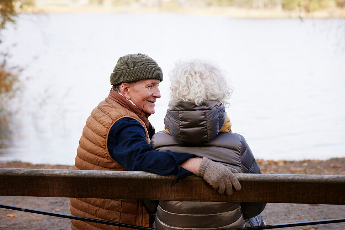 Senior couple resting at lakeside