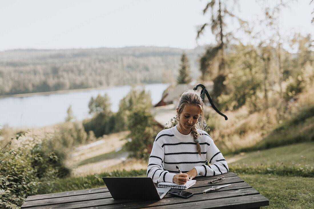 Young woman taking notes