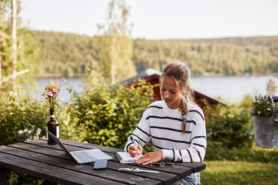 Smiling woman taking notes