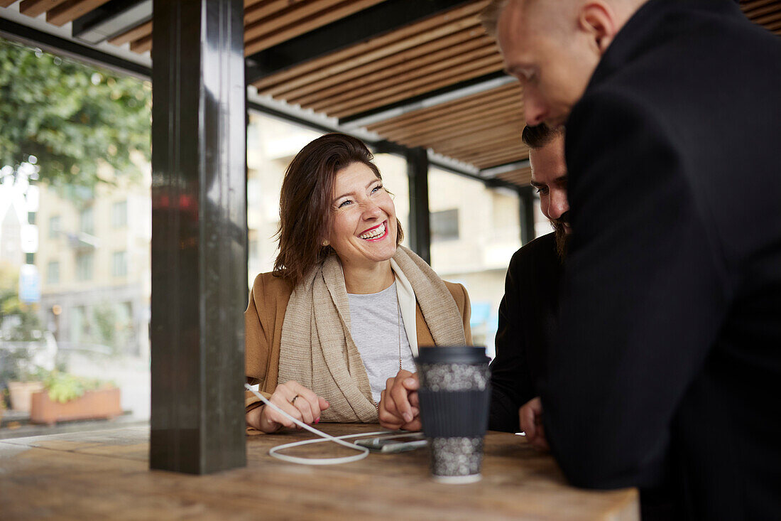 Smiling business people talking together