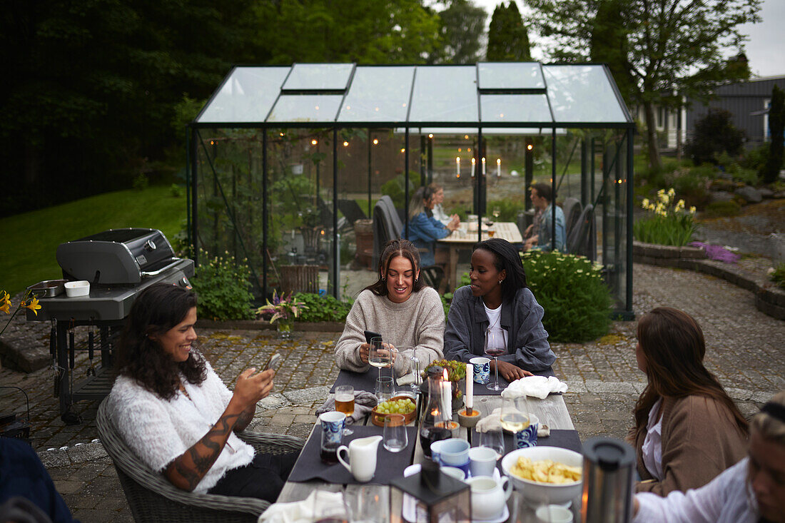 Friends having meal in garden