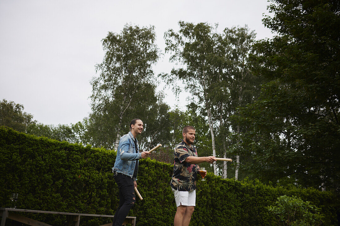 Friends playing molkky in garden