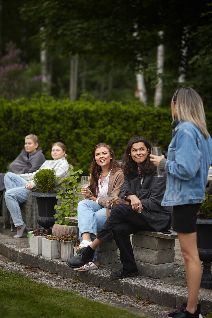 Smiling women talking in garden