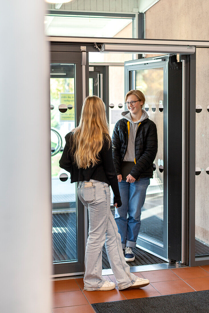 Teenage kids talking in school entrance