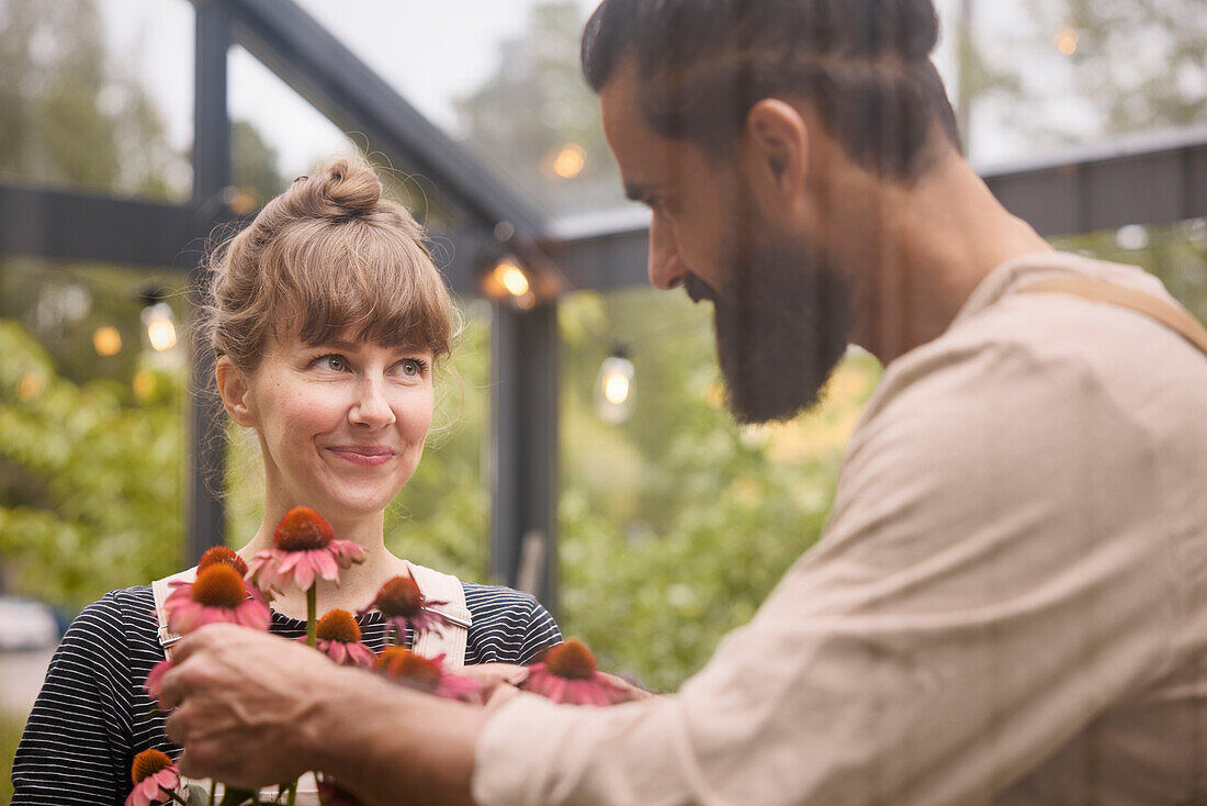 Smiling couple in greenhouse