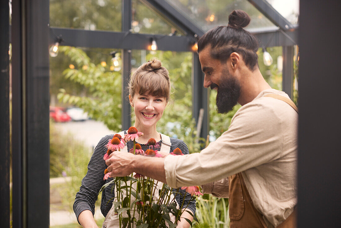 Smiling couple in greenhouse