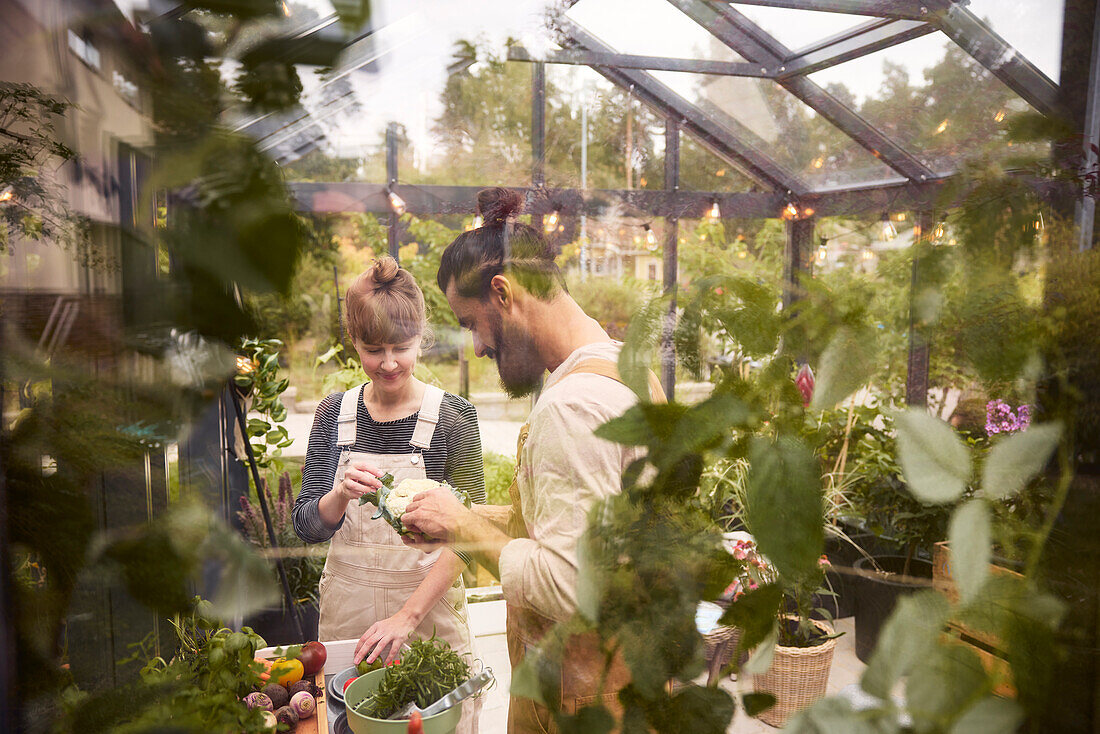 Smiling couple in greenhouse