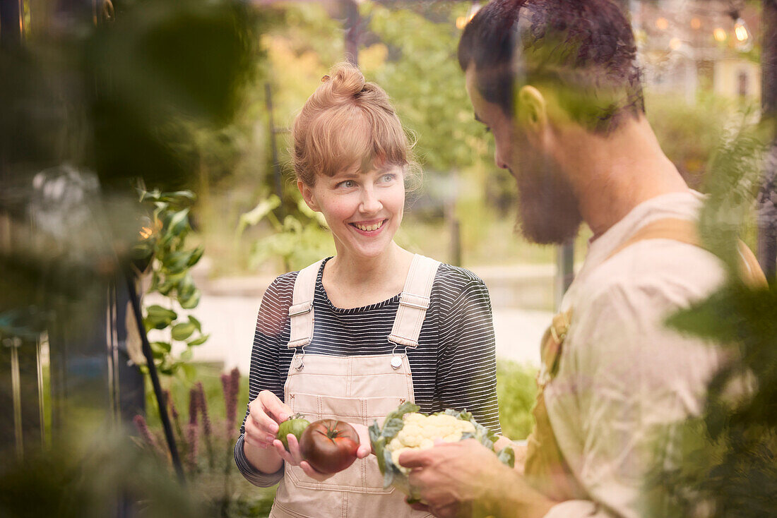 Smiling couple in greenhouse