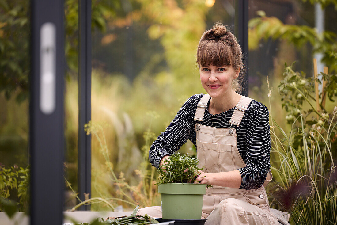 Smiling woman in greenhouse