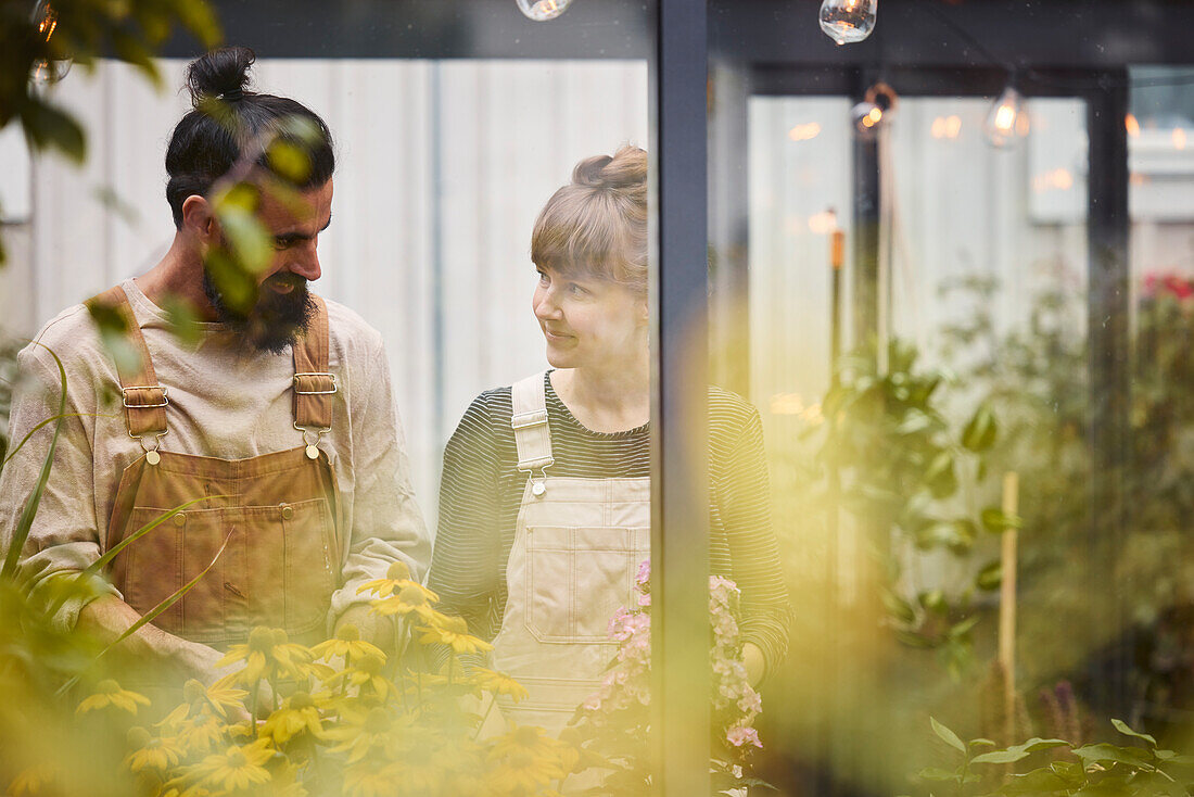 Smiling couple in greenhouse