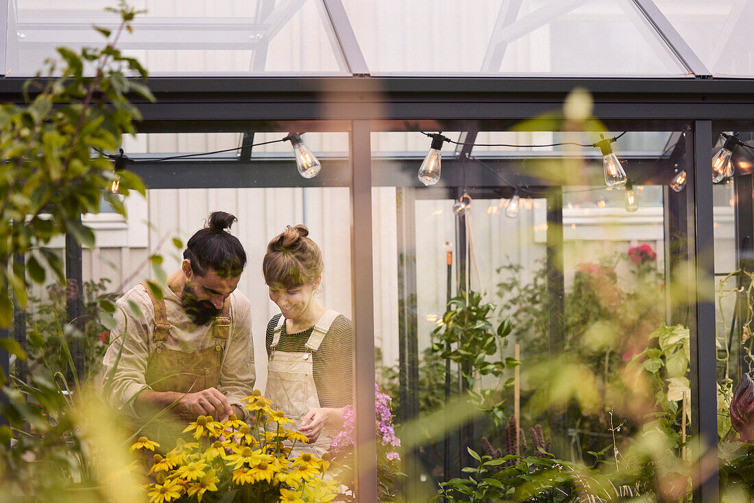 Smiling couple in greenhouse