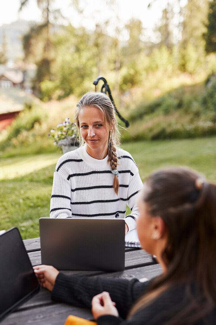 Smiling woman using laptop