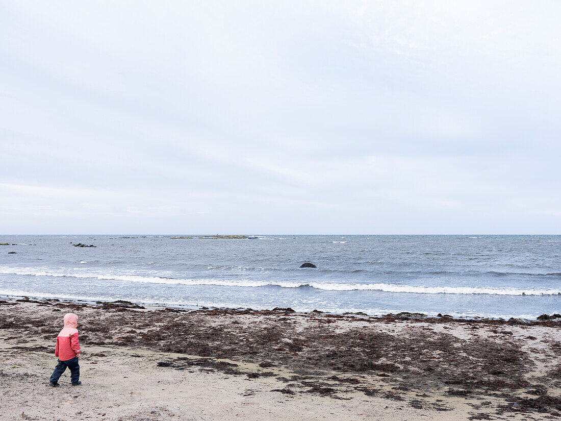 Girl walking towards sea