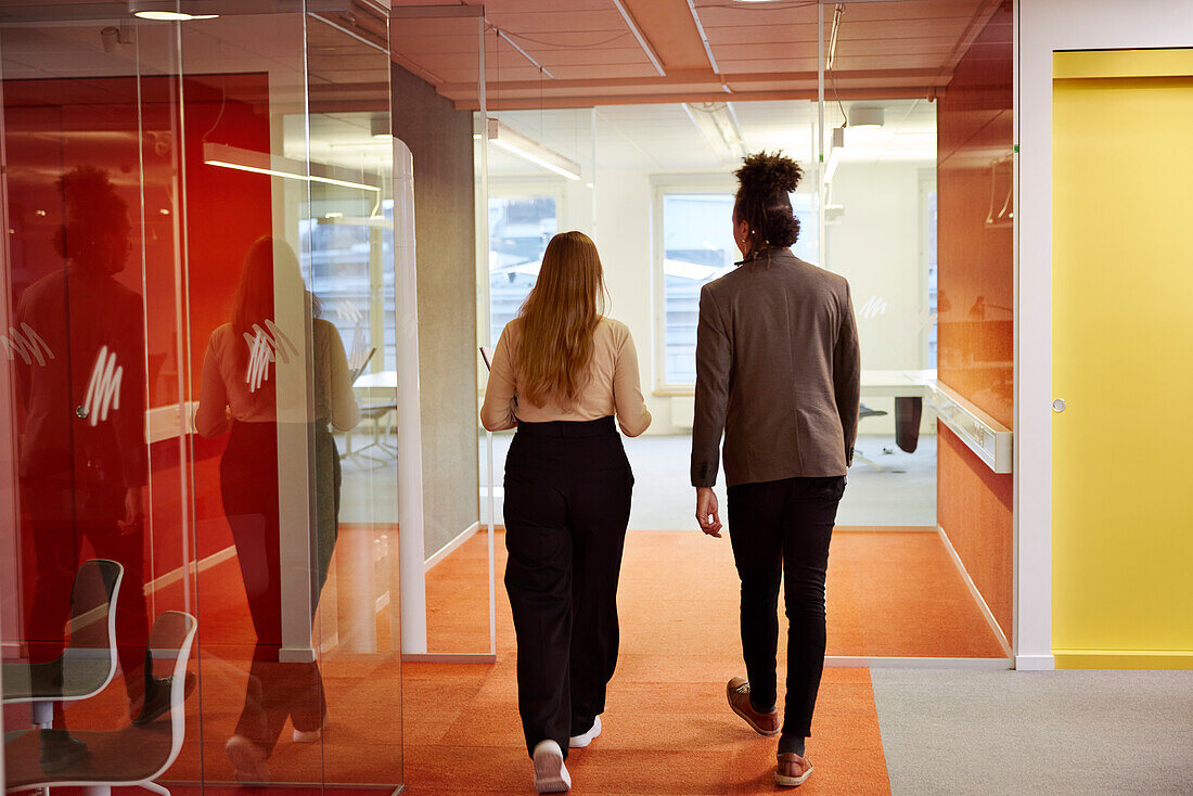 Business people walking in office corridor