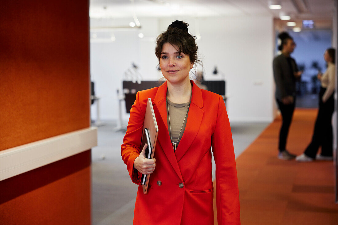Businesswoman walking in office corridor