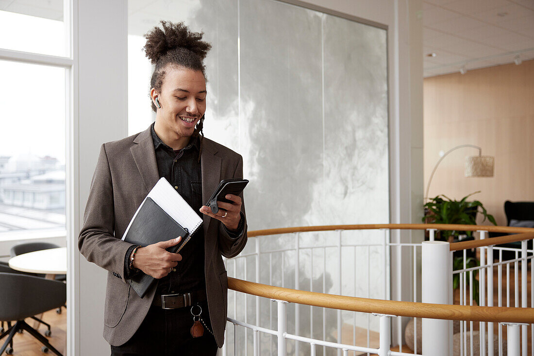 Young businessman talking on phone in office