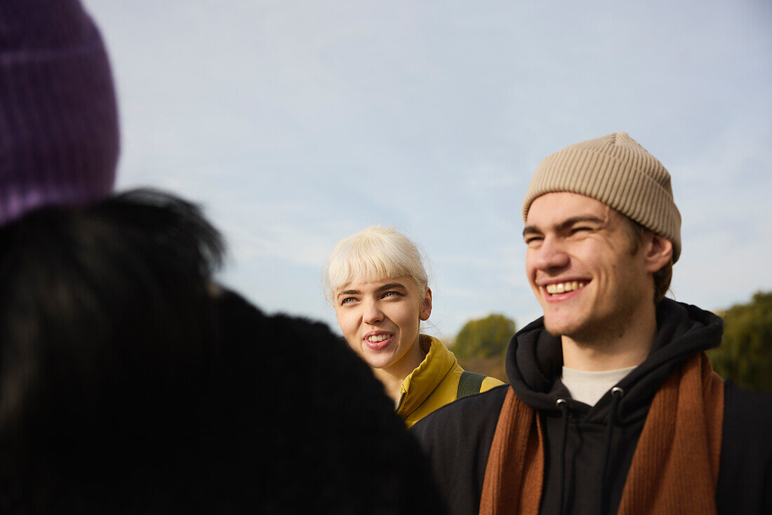 Smiling friends talking together