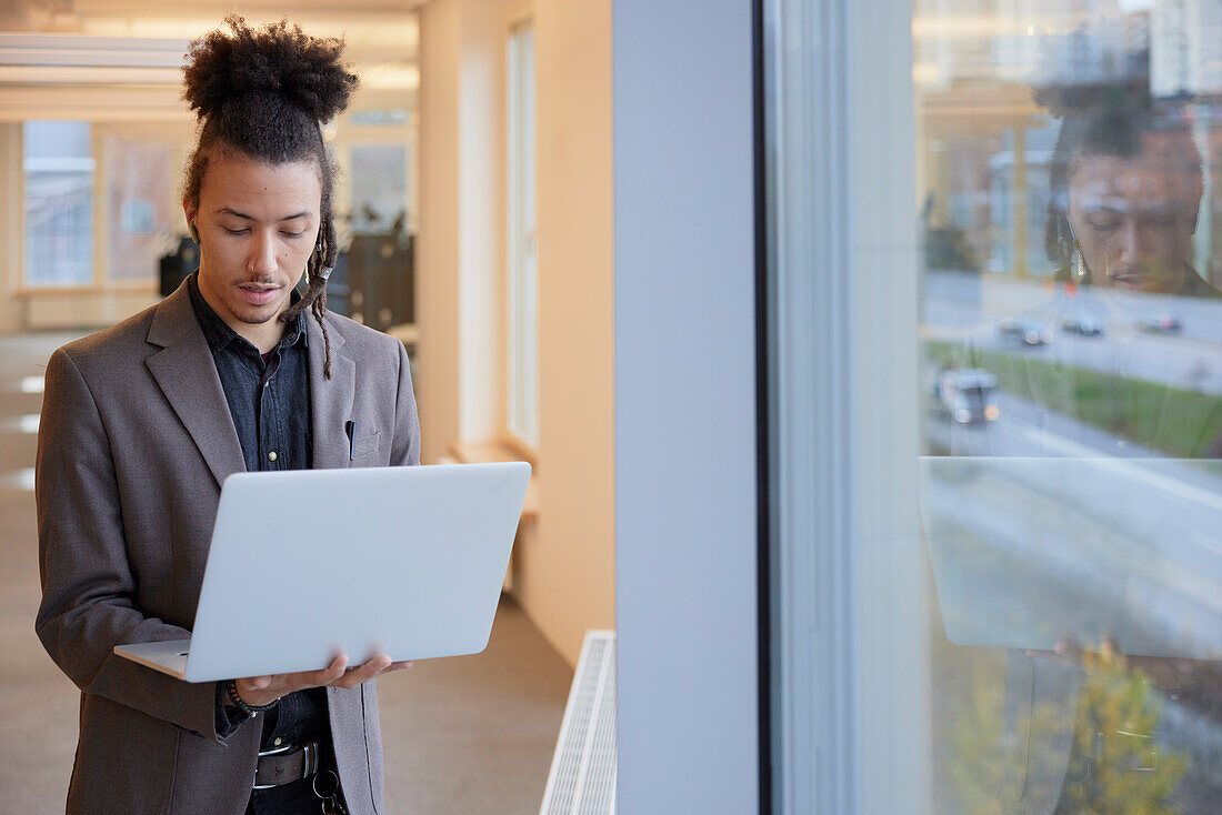 Man in office using laptop