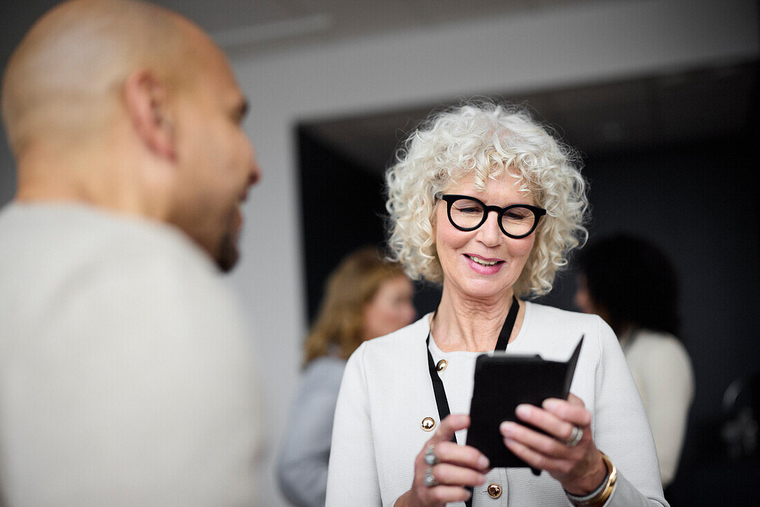 Smiling woman using cell phone