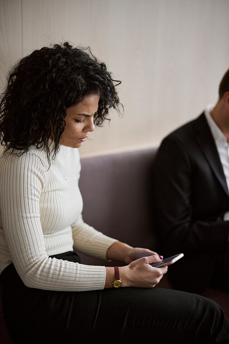 Businesswoman using cell phones