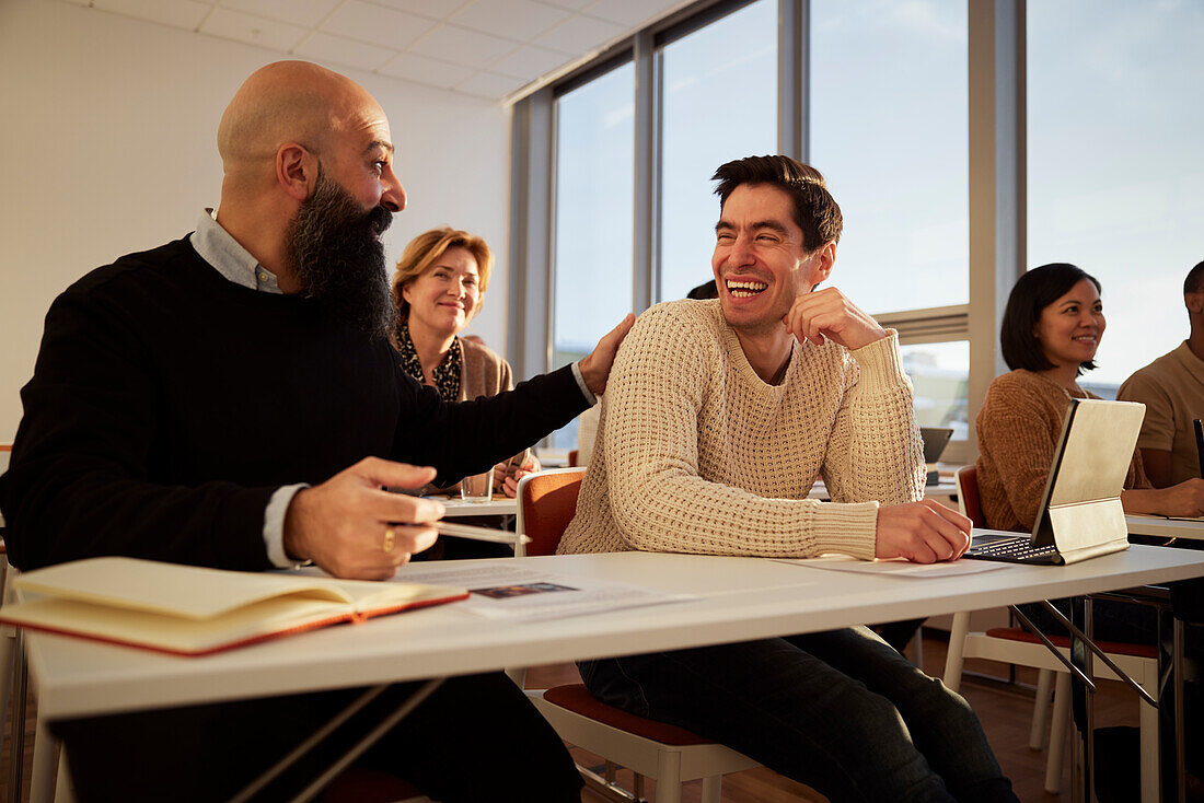 Group of adults sitting in class and laughing