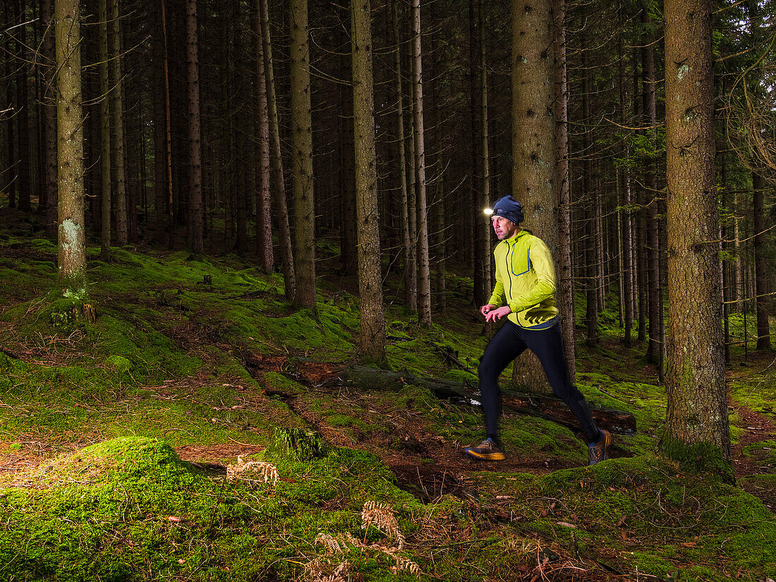 Man running through forest