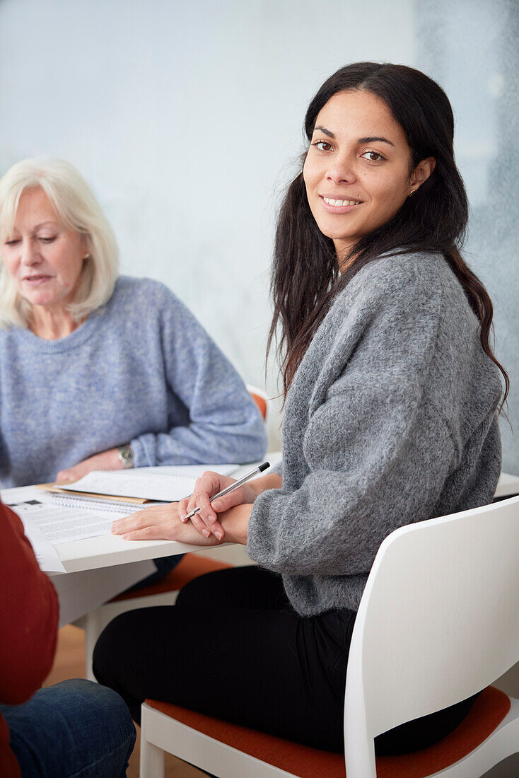 Smiling woman sitting at workshop