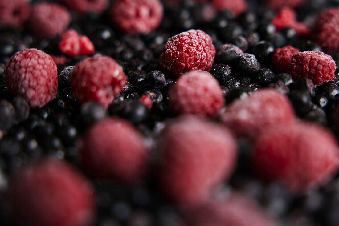 Nahaufnahme eines Stapels Himbeeren und schwarzer Johannisbeeren