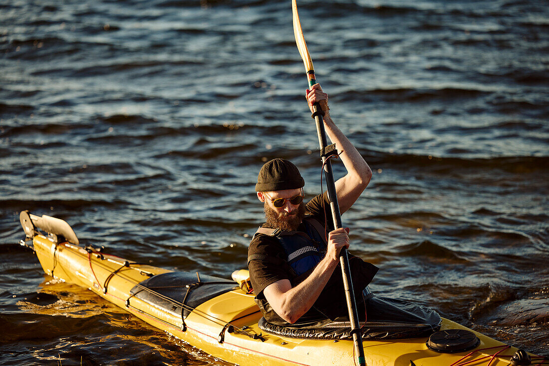 Man in yellow kayak holding oar