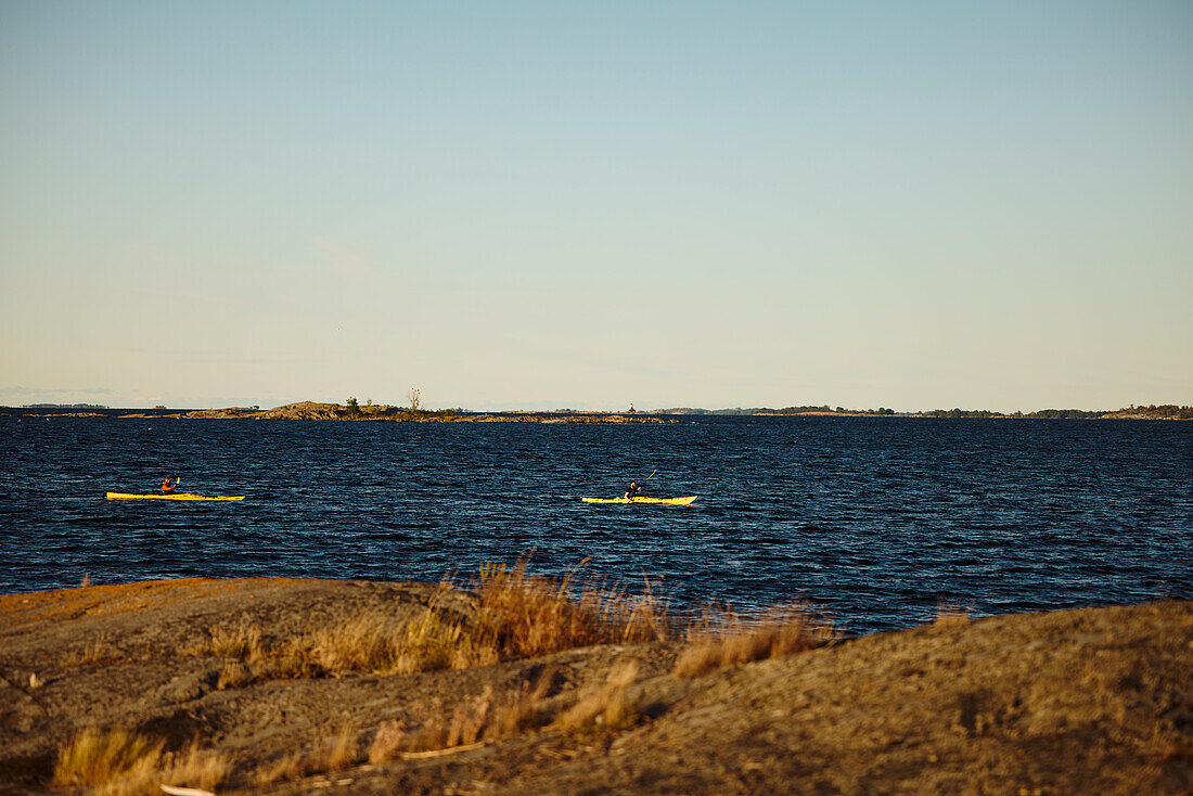 People kayaking on sunny autumn day