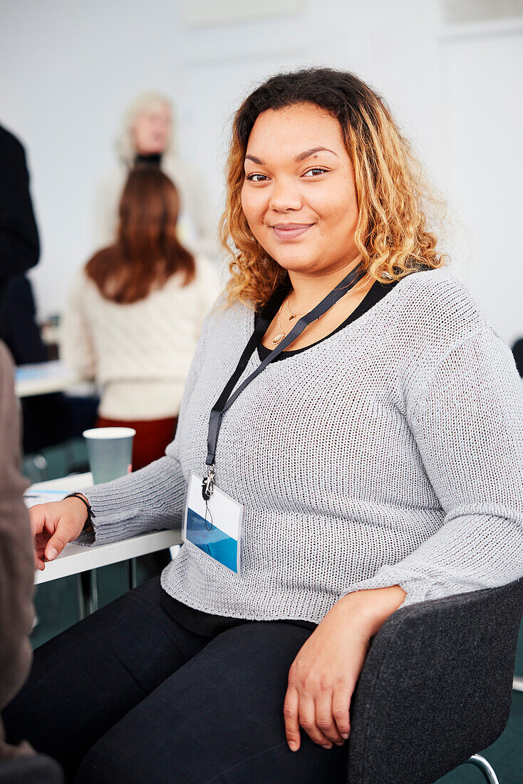 Portrait of young businesswoman sitting at desk