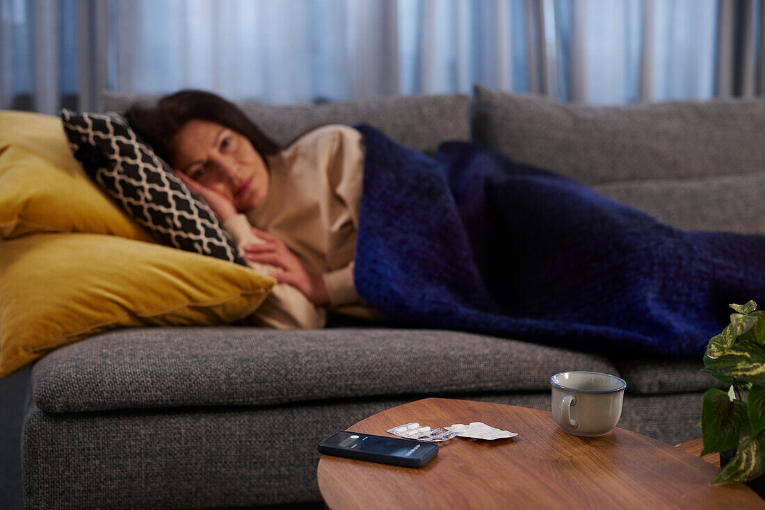 Woman lying down on sofa