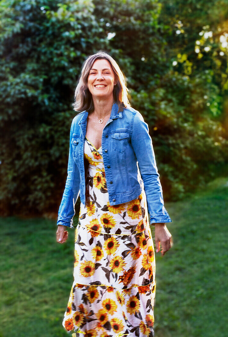 Smiling woman standing in garden