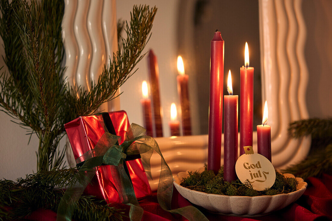 Candles and christmas decoration on table