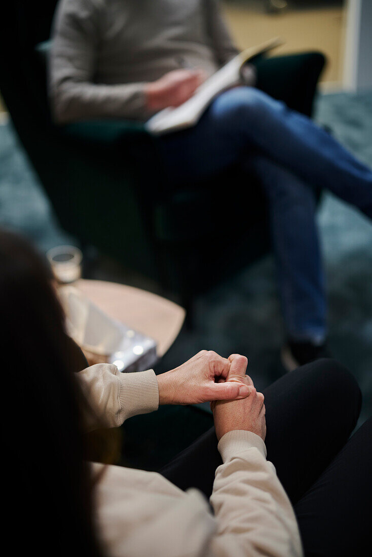 Female patient wringing hands at therapy session