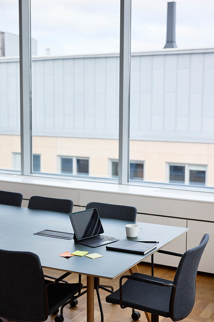 Digital tablet and diary on meeting table