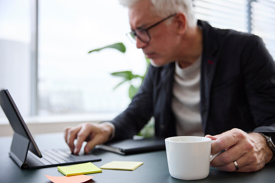 Businessman using digital tablet in office