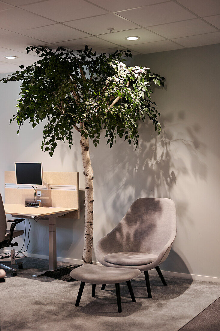 Armchair with footstool in office lobby