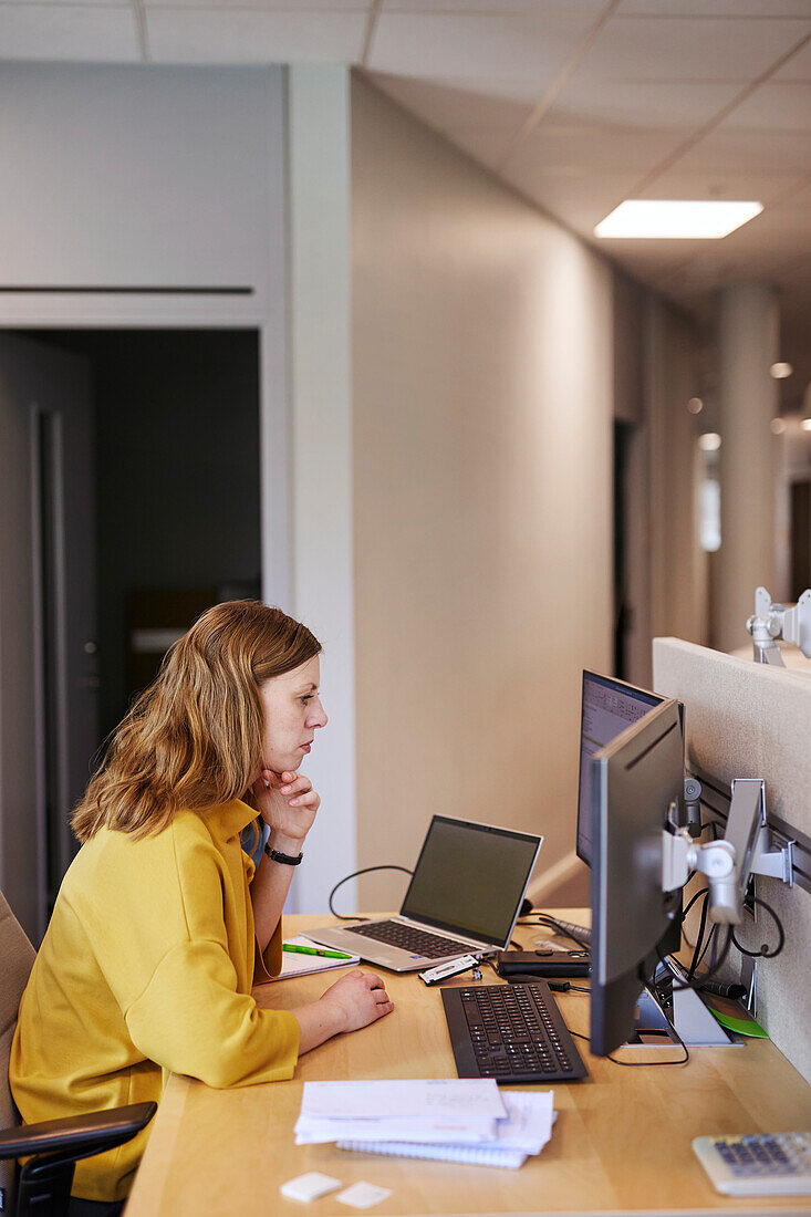 Woman using computer in office