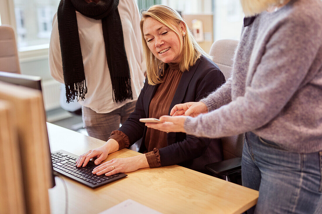 Women talking to each other in office