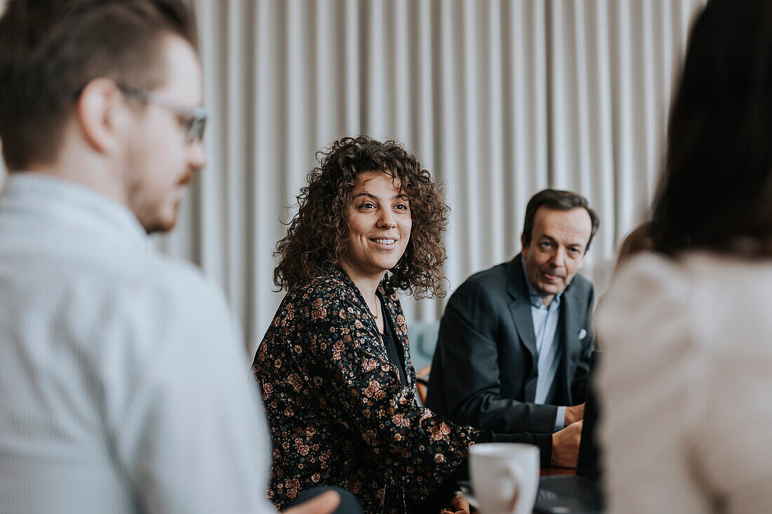 Smiling woman at business meeting