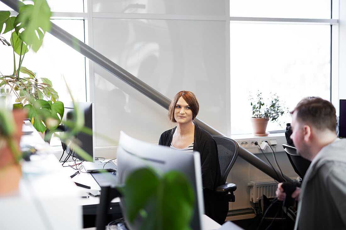 Man and woman talking in office